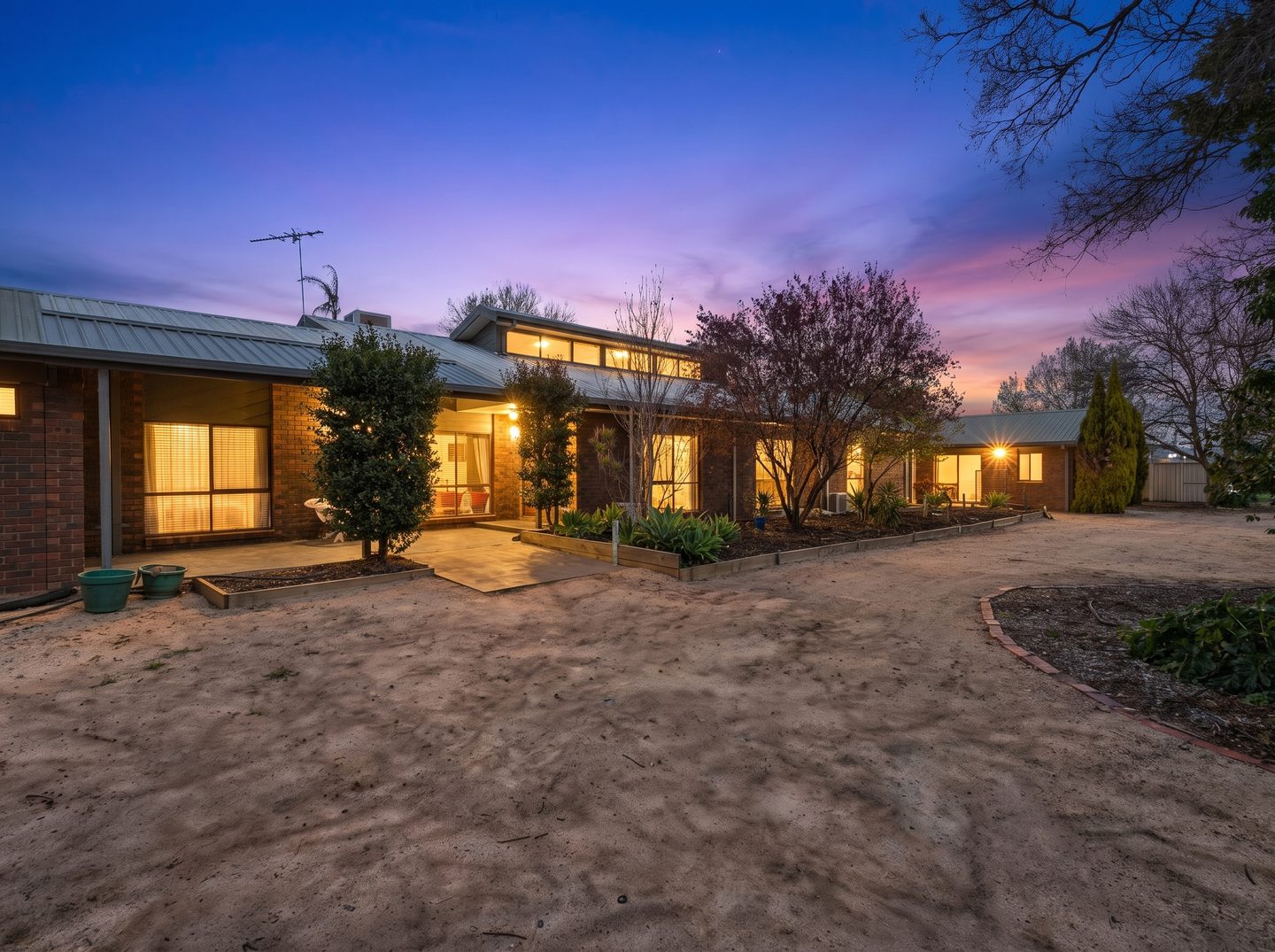 The brick home and front garden at dusk