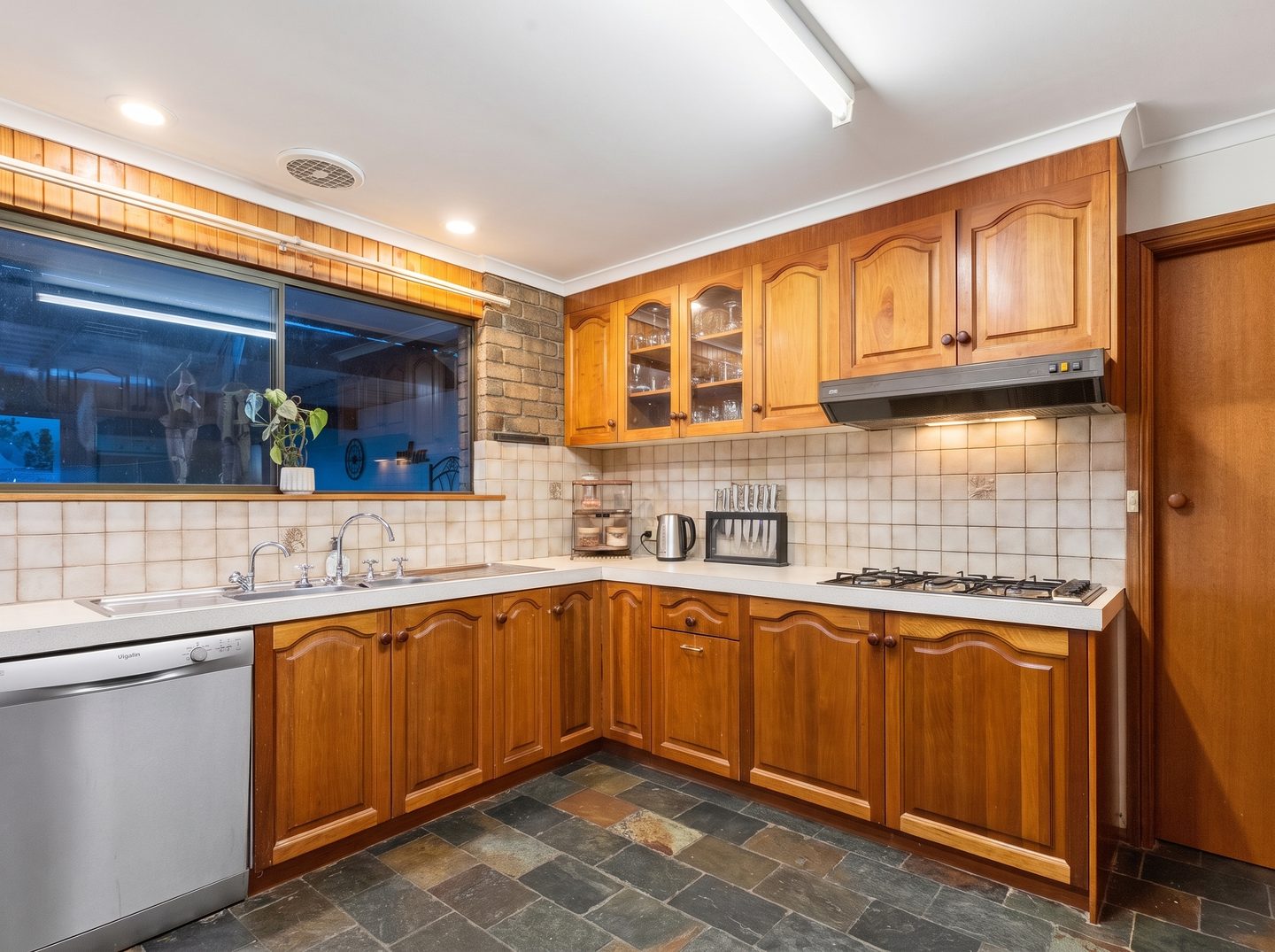 Timber kitchen cabinetry and wide window