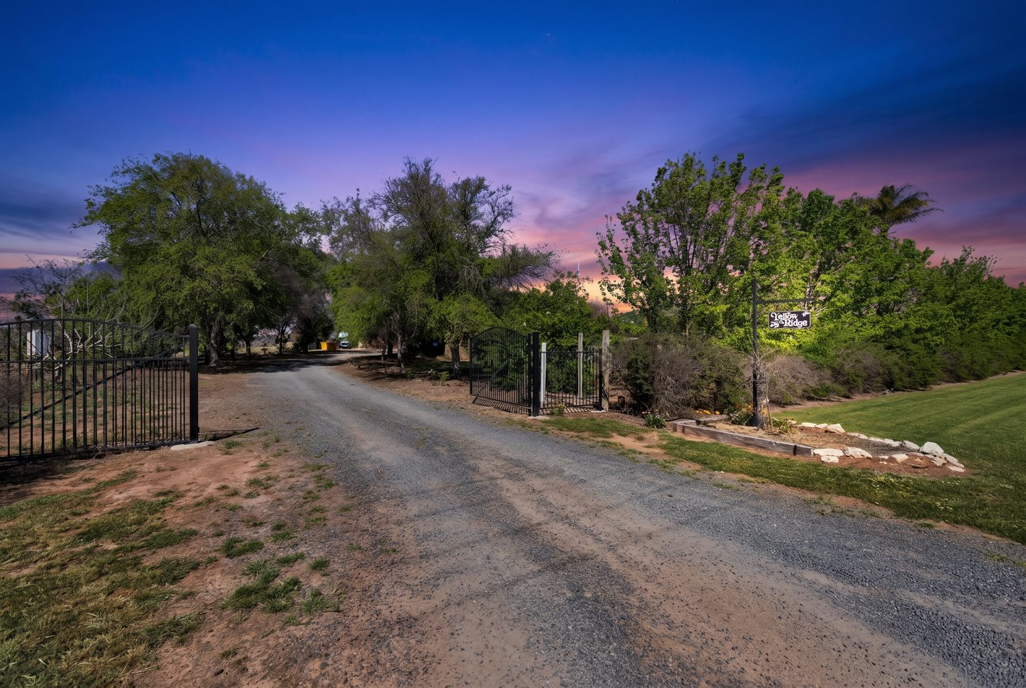 Gated driveway entrance at dusk