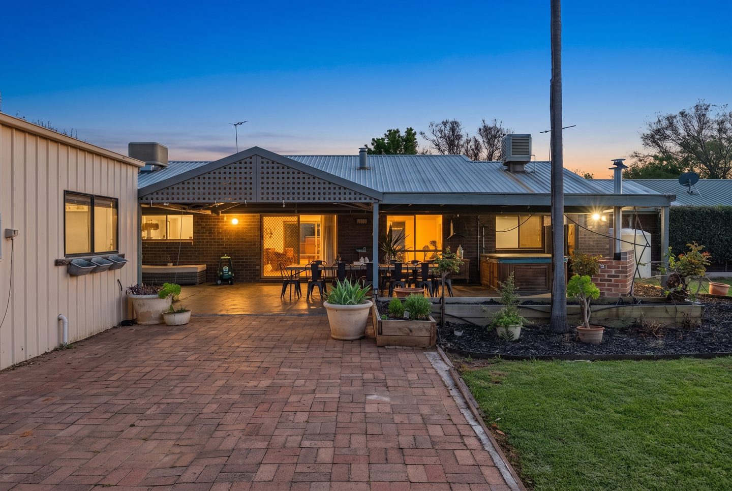 Paved entertaining area beside the home