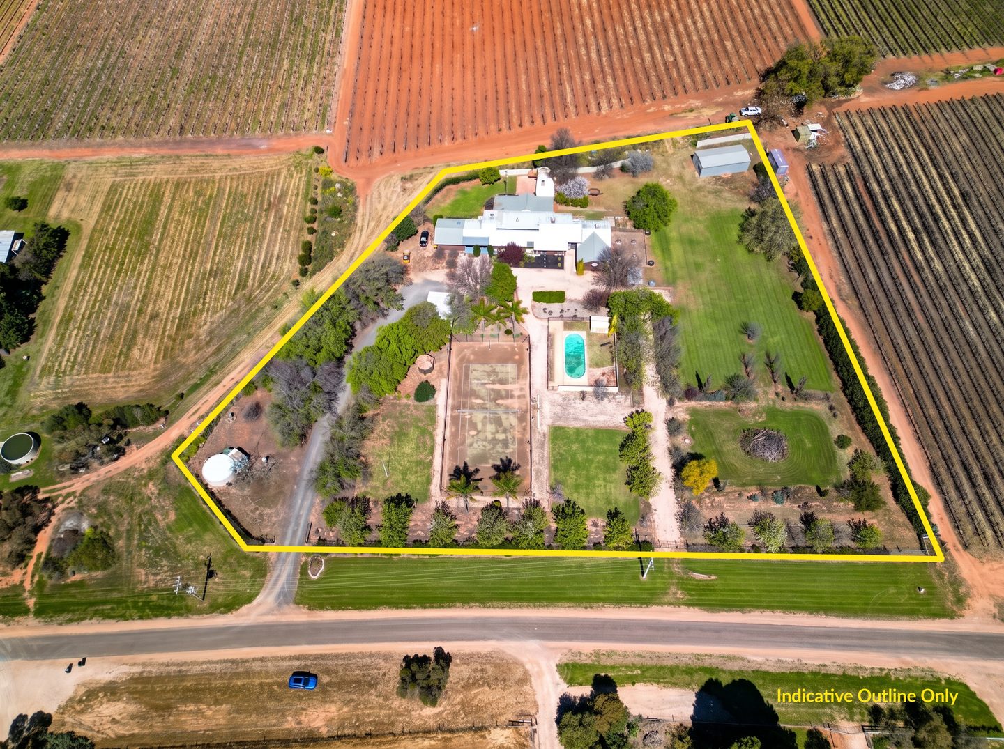 Aerial view of the house, pool, tennis court and grounds with an indicative property outline